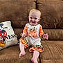 architecture, baby, building, clothing, couch, cushion, face, furniture, happy, head, homedecor, indoors, livingroom, person, photography, pillow, portrait, room, shorts, sitting