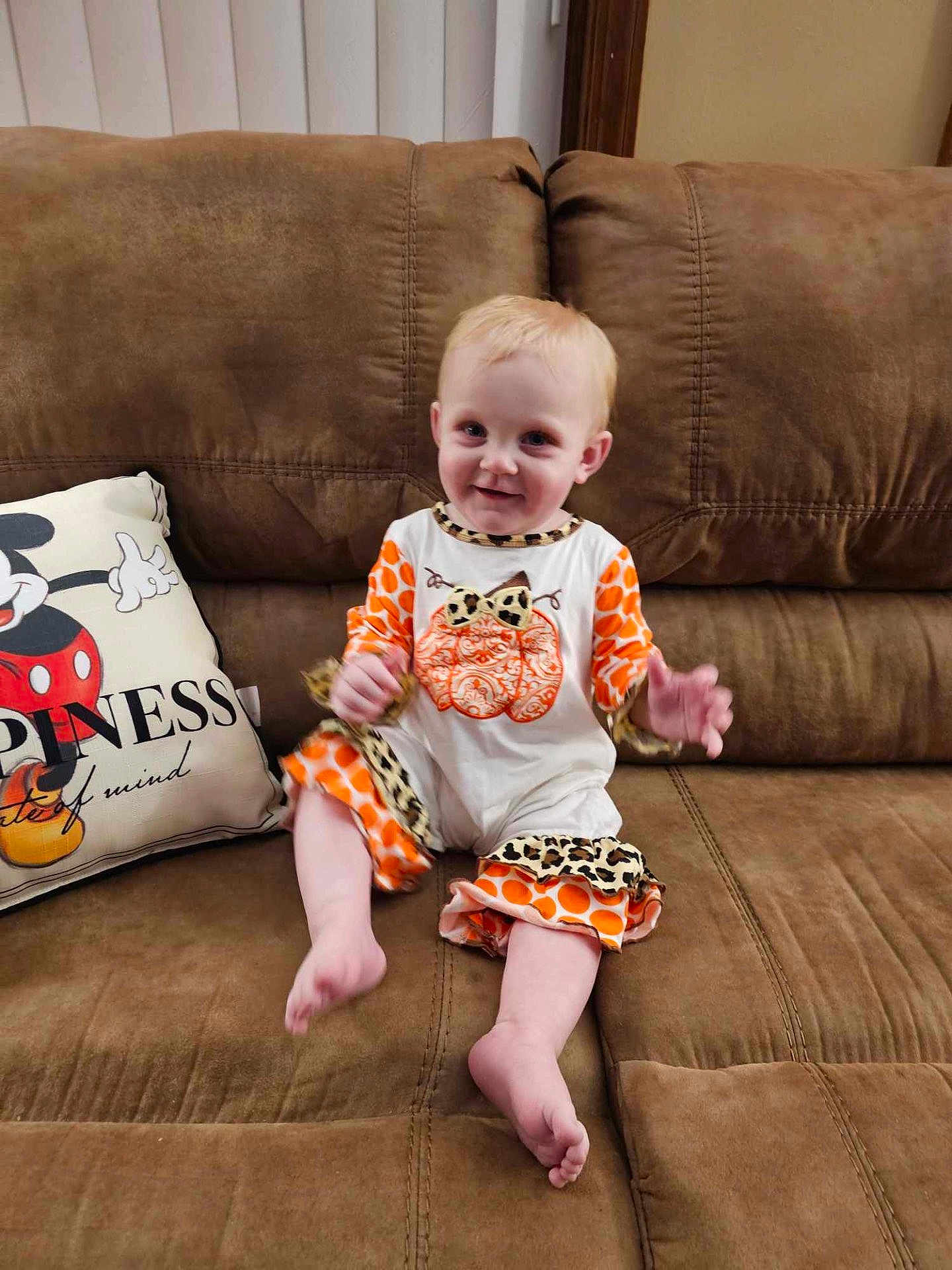 Eleanor is registered to the contest to win money with this photo: architecture, baby, building, clothing, couch, cushion, face, furniture, happy, head, homedecor, indoors, livingroom, person, photography, pillow, portrait, room, shorts, sitting