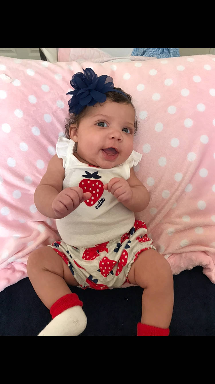 Khelani is registered to the contest to win money with this photo: baby, baby_toddler_clothing, beauty, cheek, child, child_model, design, facial_expression, hair_accessory, happy, pattern, person, photography, pink, polka_dot, red, sitting, skin, smile, toddler