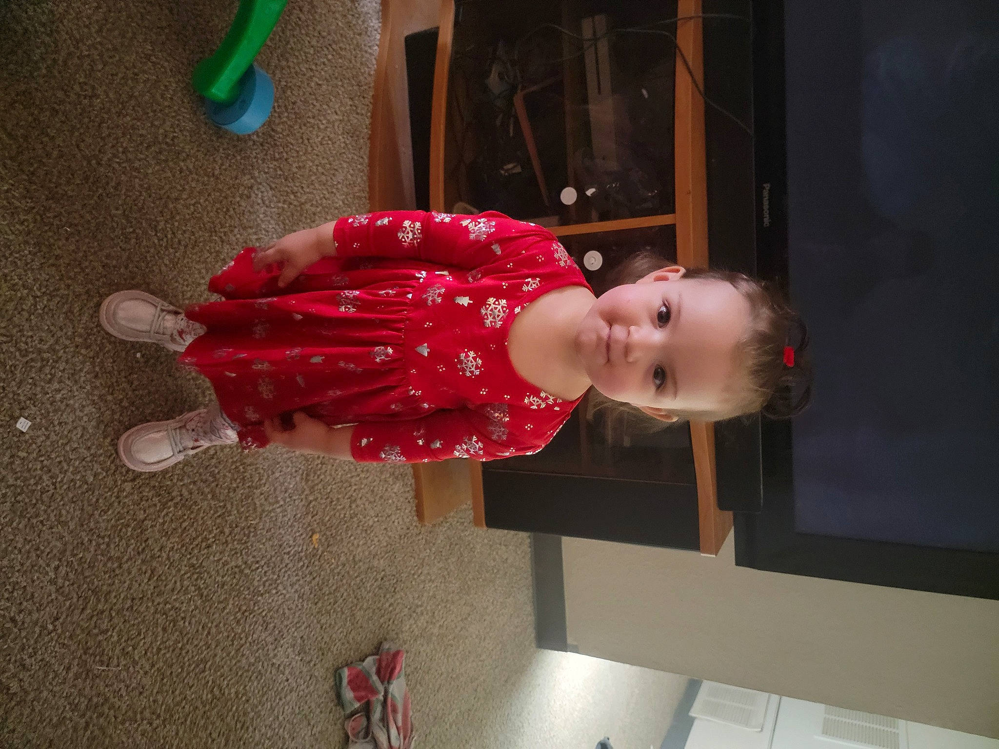 Liliana is registered to the contest to win money with this photo: baby, baby_toddler_clothing, carmine, child, dress, flooring, foot, fun, human_leg, joy, magenta, person, pink, room, sitting, smile, sock, toddler, wood