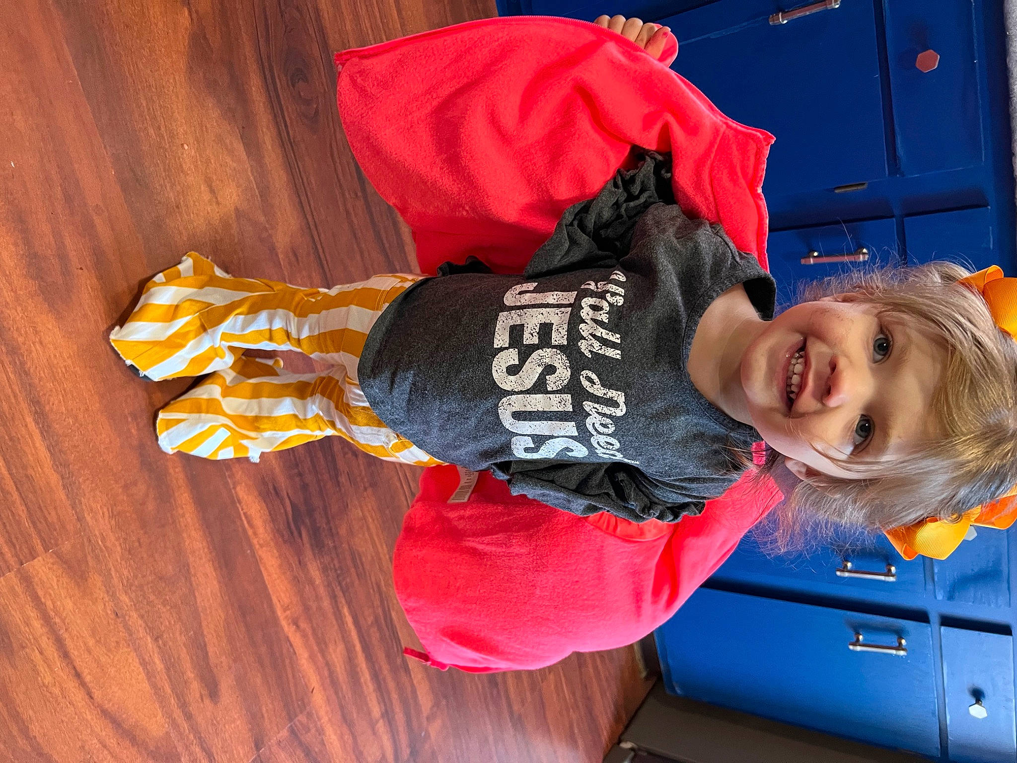 Georgia is registered to the contest to win money with this photo: baby_toddler_clothing, child, electric_blue, flooring, fun, happy, hardwood, jacket, joy, leisure, motor_vehicle, orange, person, sleeve, smile, sportswear, t_shirt, toddler, travel, vehicle_door