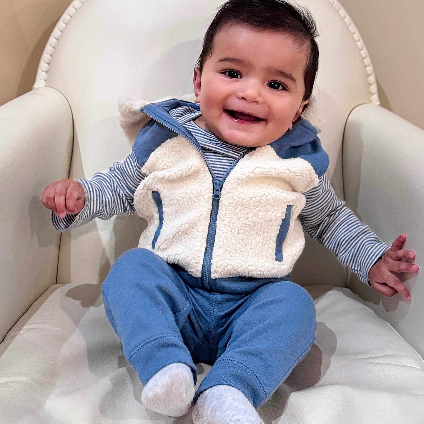 Ansh Dharampuriya joined the competition — help win amazing prizes! armchair, baby, blue_pants, child, clothing, comfortable, cozy, cute, face, fleece_vest, furniture, happy, indoor, infant, person, portrait, seated, skin, smiling, socks