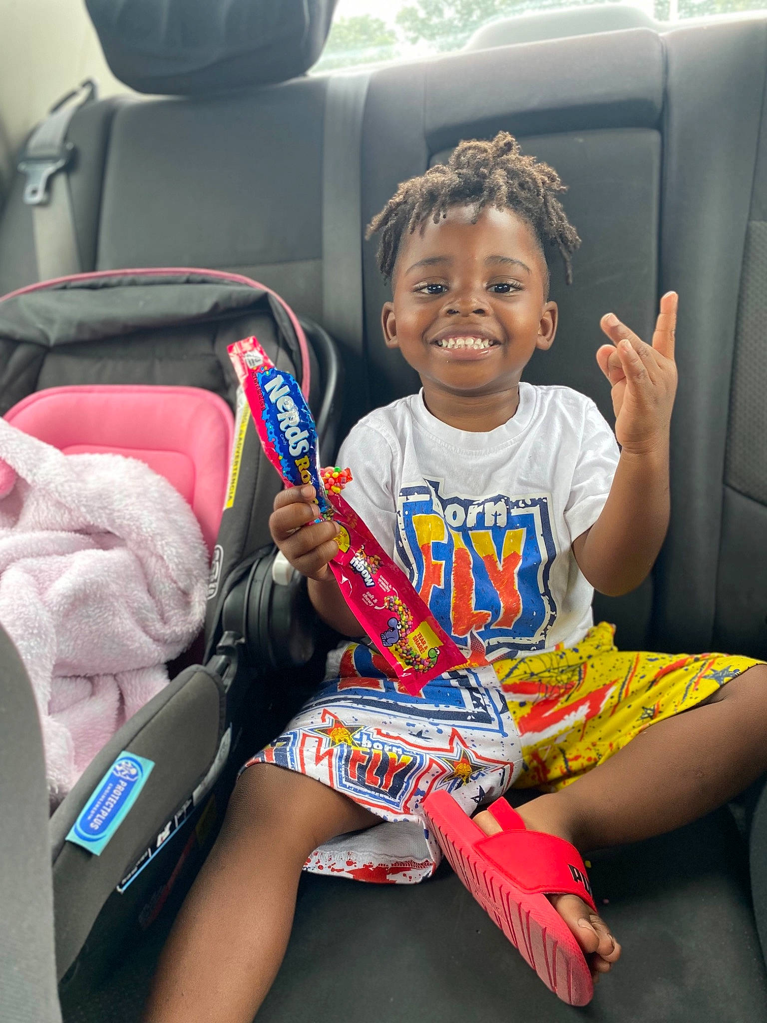 Jamari is registered to the contest to win money with this photo: auto_part, automotive_design, car_seat, child, cool, face, fun, hairstyle, happy, head, head_restraint, joy, lap, motor_vehicle, person, product, smile, thigh, toddler, travel