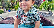 Yuvaan joined the competition — help win amazing prizes! child, toddler, baby, boy, smiling, portrait, outdoor, garden, palm_trees, tropical, blue_sky, bench, seated, clothing, patterned_shirt, shorts, sneakers, bracelet, playground, sunny