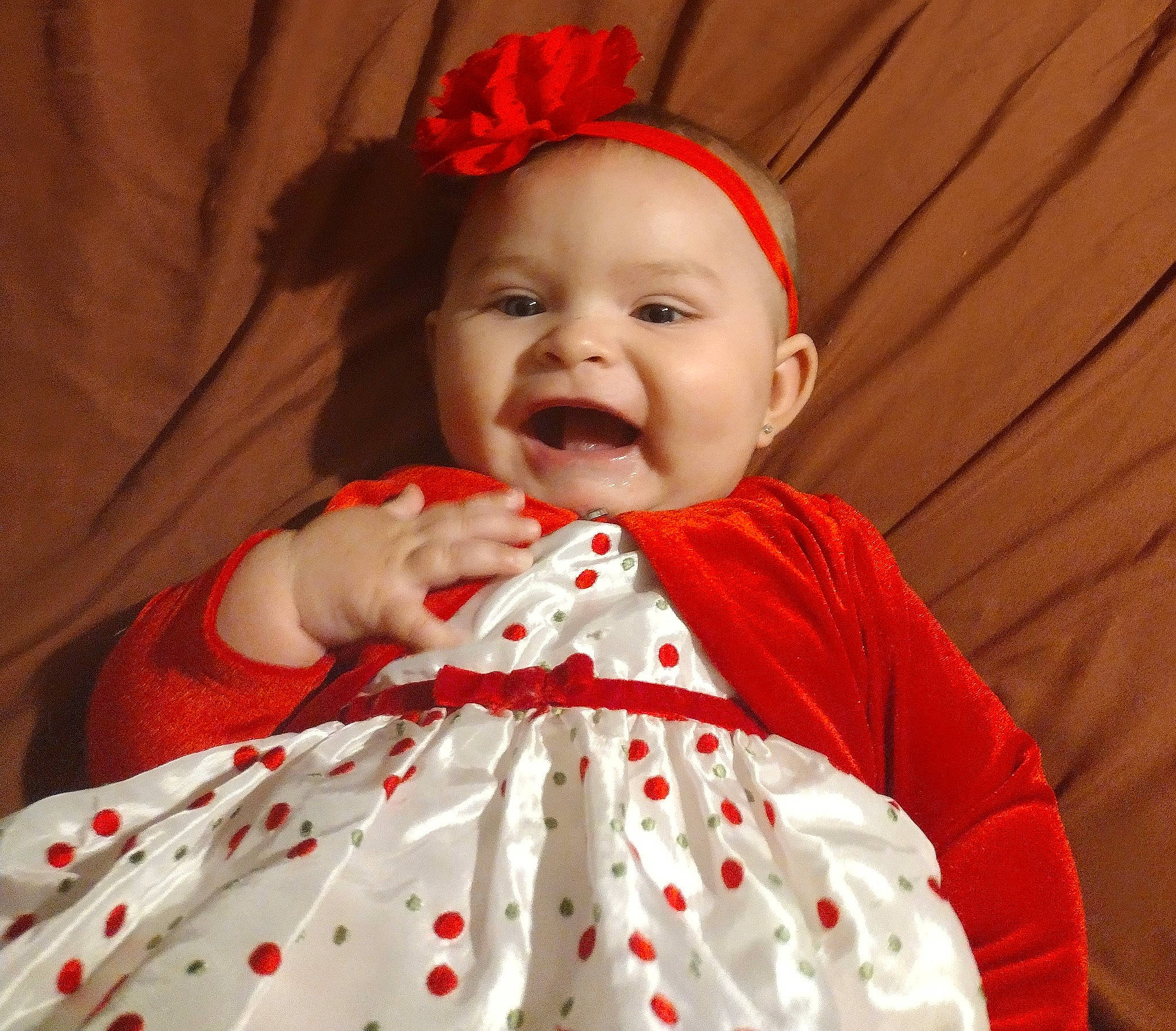 Erin is registered to the contest to win money with this photo: baby, baby_laughing, baby_toddler_clothing, cheek, comfort, event, face, happy, human_body, lip, organ, outerwear, pattern, person, pink, red, skin, sleeve, smile, t_shirt
