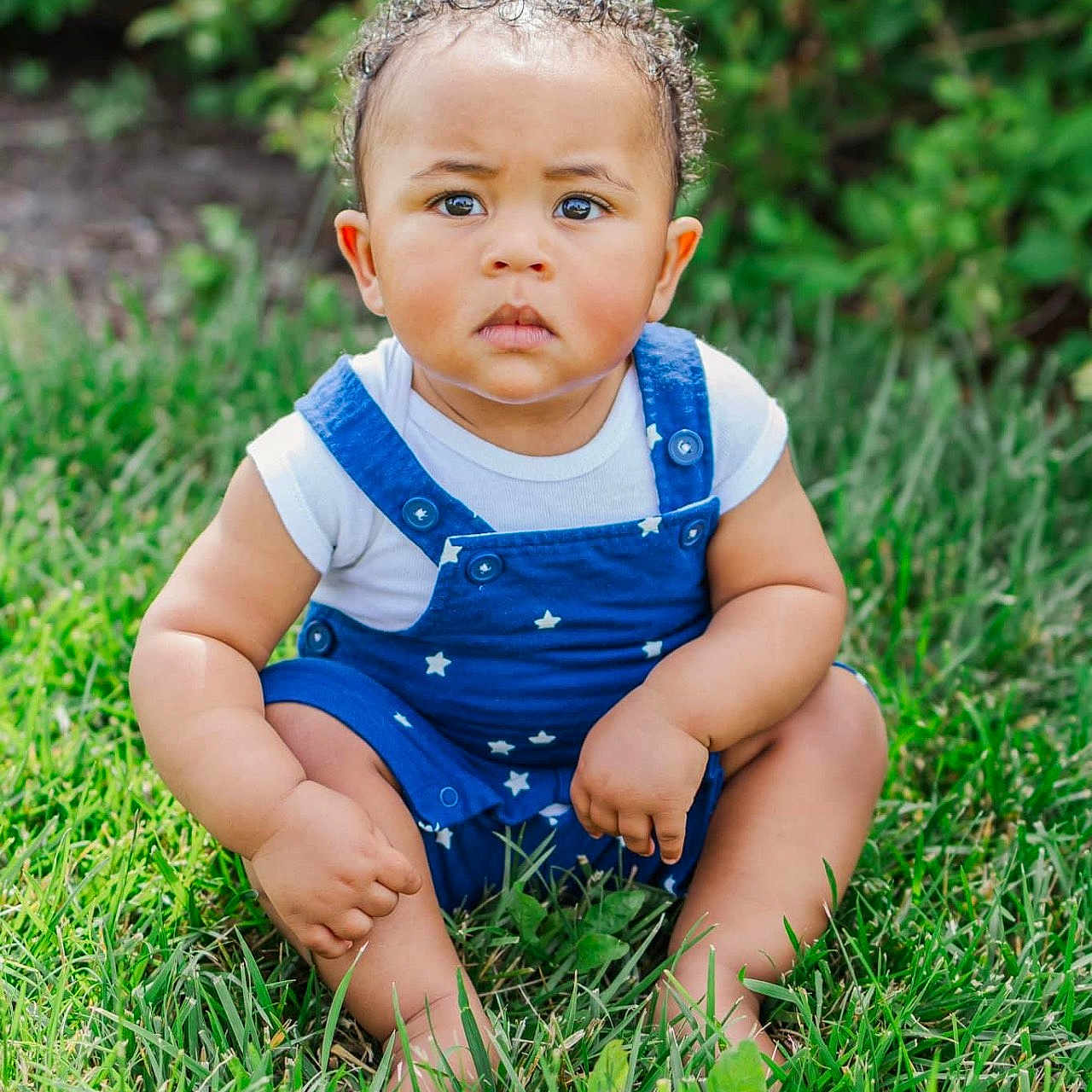 Amari is registered to the contest to win money with this photo: baby, backyard, clothing, crawling, face, frown, grass, head, jeans, lawn, nature, outdoors, pants, person, photography, plant, portrait, sad, sitting, yard
