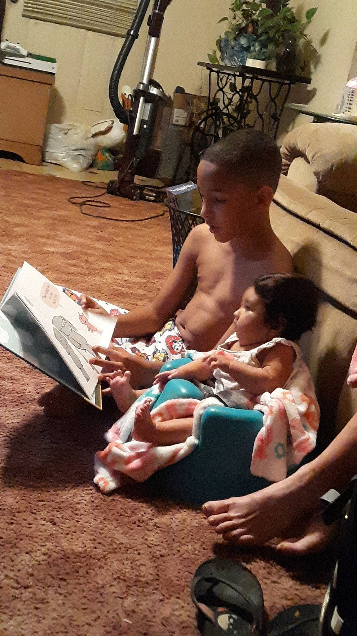 Jayden is registered to the contest to win money with this photo: baby, child, person, reading, sitting