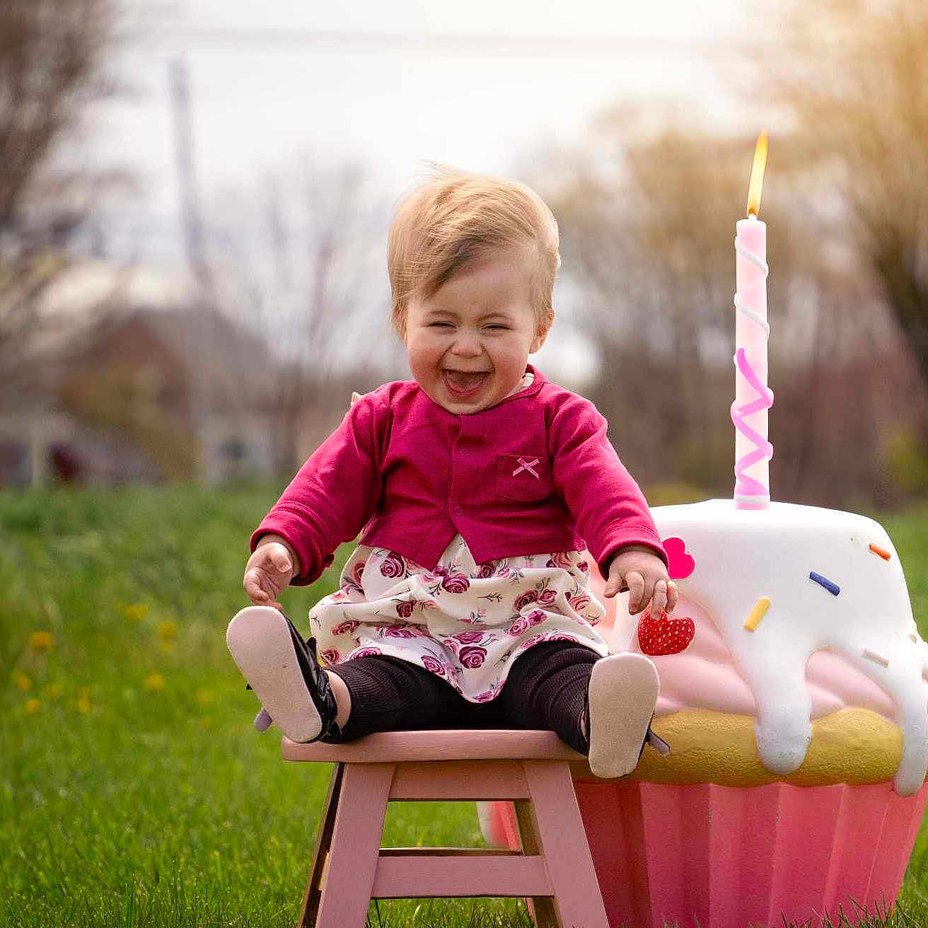 Delilah is registered to the contest to win money with this photo: baby, birthdaycake, cake, candle, clothing, cream, dessert, face, food, grass, head, hosiery, outdoors, people, person, photography, plant, portrait, sitting, sock