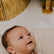 Kolton is registered to the contest to win money with this photo: baby, infant, child, smiling, happy, face, cute, portrait, indoors, soft_cushion, clothing, festive, gingerbread, santa_claus, holiday, cozy, closeup, skin, head, eyes