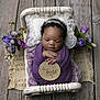 newborn, baby, sleeping, purple, blanket, headband, flower, wooden_sign, bed, pillow, portrait, infant, resting, cute, cozy, decor, hands, wood_floor, wrapped, peaceful