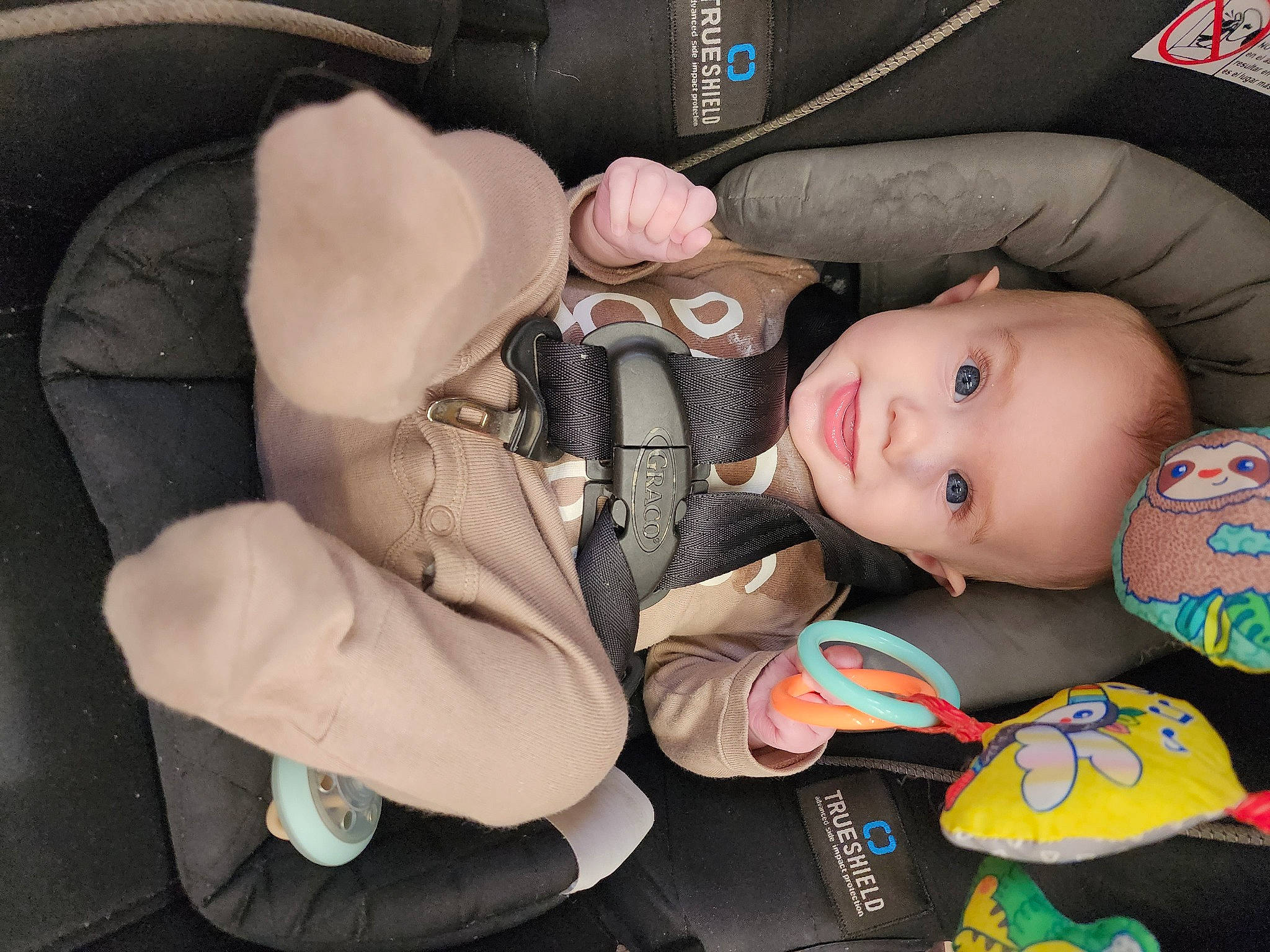Colton is registered to the contest to win money with this photo: auto_part, baby, baby_carriage, baby_products, baby_toddler_clothing, car, car_seat, car_seat_cover, carmine, cheek, child, comfort, luxury_vehicle, motor_vehicle, person, sitting, steering_wheel, stuffed_toy, toddler, toy