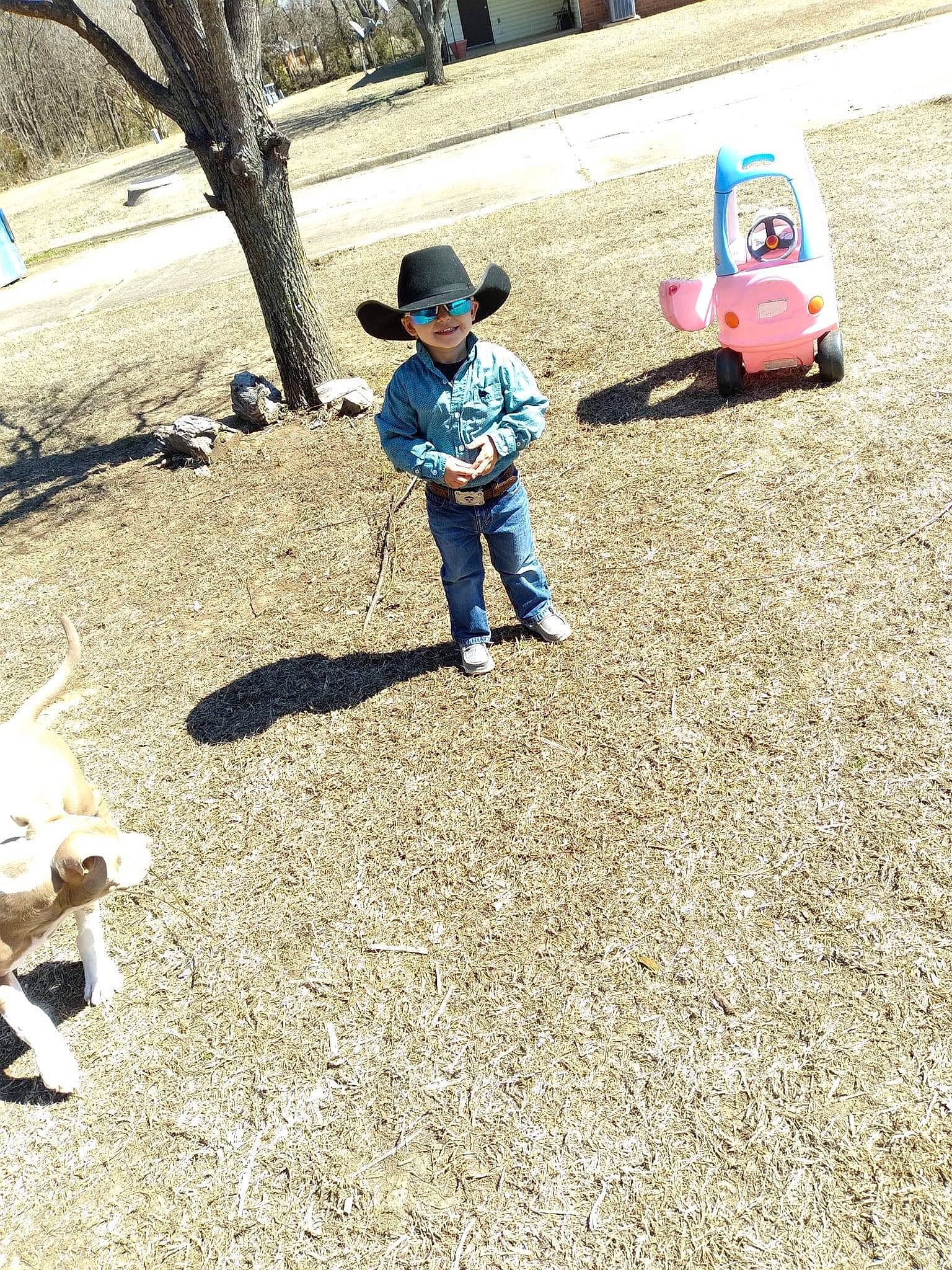 Brantley is registered to the contest to win money with this photo: asphalt, baby, child, city, fun, grass, headwear, joy, lawn, leisure, people_in_nature, person, playground, recreation, riding_toy, road_surface, sand, soil, tire, toddler