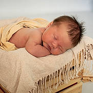 Austin is registered to the contest to win money with this photo: newborn, baby, sleeping, blanket, wooden_crate, soft, cozy, infant, rest, peaceful, skin, head, hair, indoors, portrait, cute, child, wrapped, toddler, relax