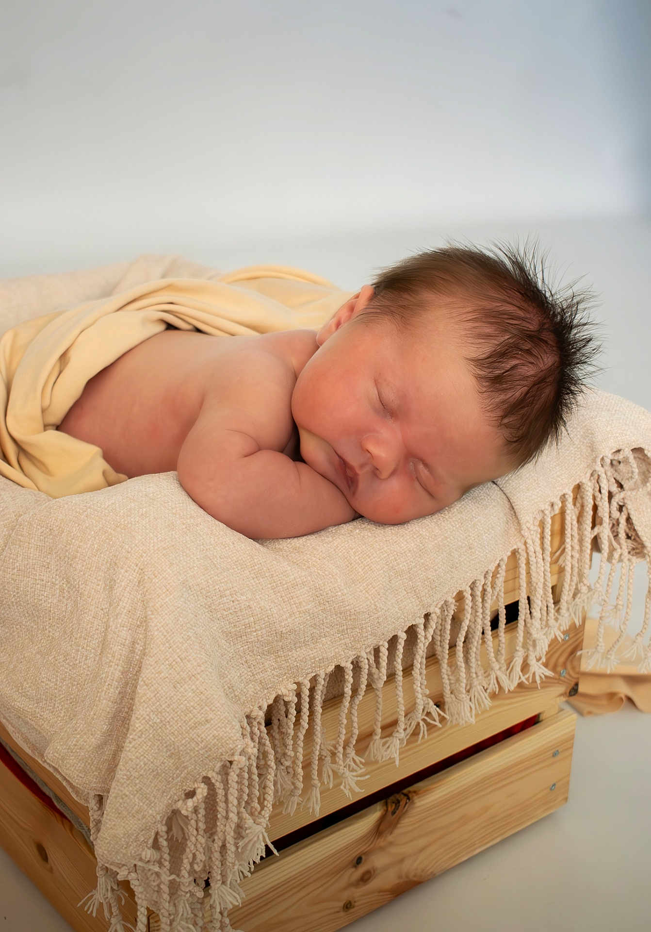 Austin is registered to the contest to win money with this photo: newborn, baby, sleeping, blanket, wooden_crate, soft, cozy, infant, rest, peaceful, skin, head, hair, indoors, portrait, cute, child, wrapped, toddler, relax