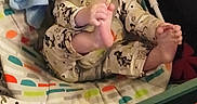 Charlie joined the competition — help win amazing prizes! toddler, child, baby_rocker, pajamas, smile, happy, indoor, toy, blanket, foot, hand, face, curly_hair, seated, colorful, patterned_clothing, plush_toy, infant, cozy, playful