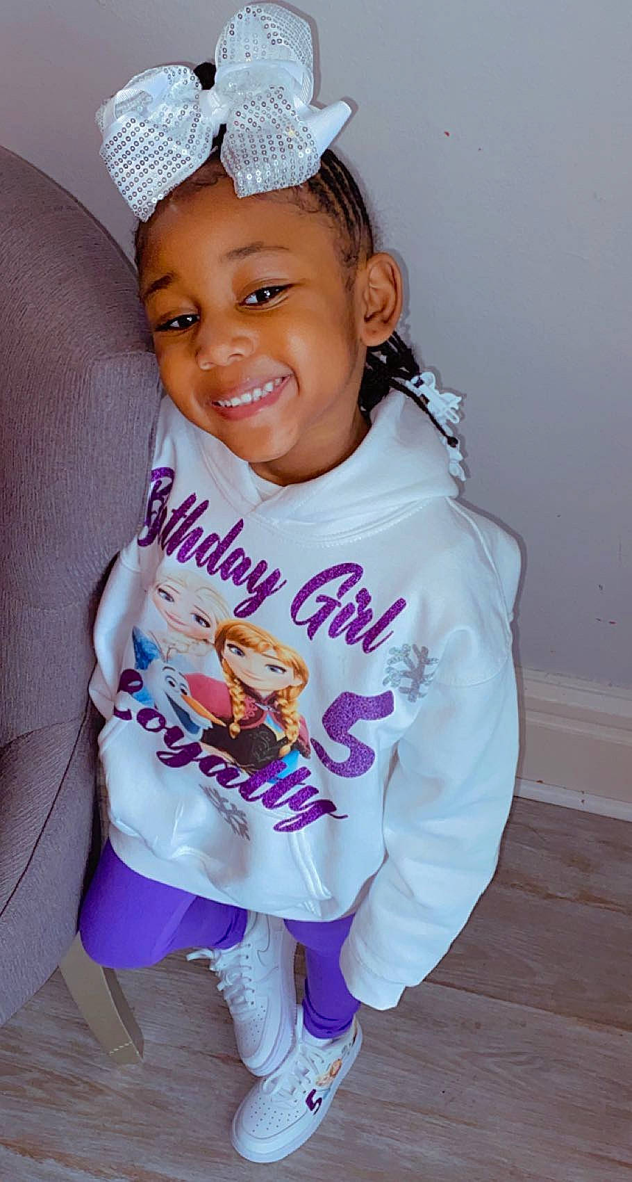 Loyalty Moss is registered to the contest to win money with this photo: arm, baby_toddler_clothing, clothing, eye, face, facial_expression, finger, gesture, happy, head, joy, outerwear, person, pink, product, purple, skin, sleeve, smile, t_shirt