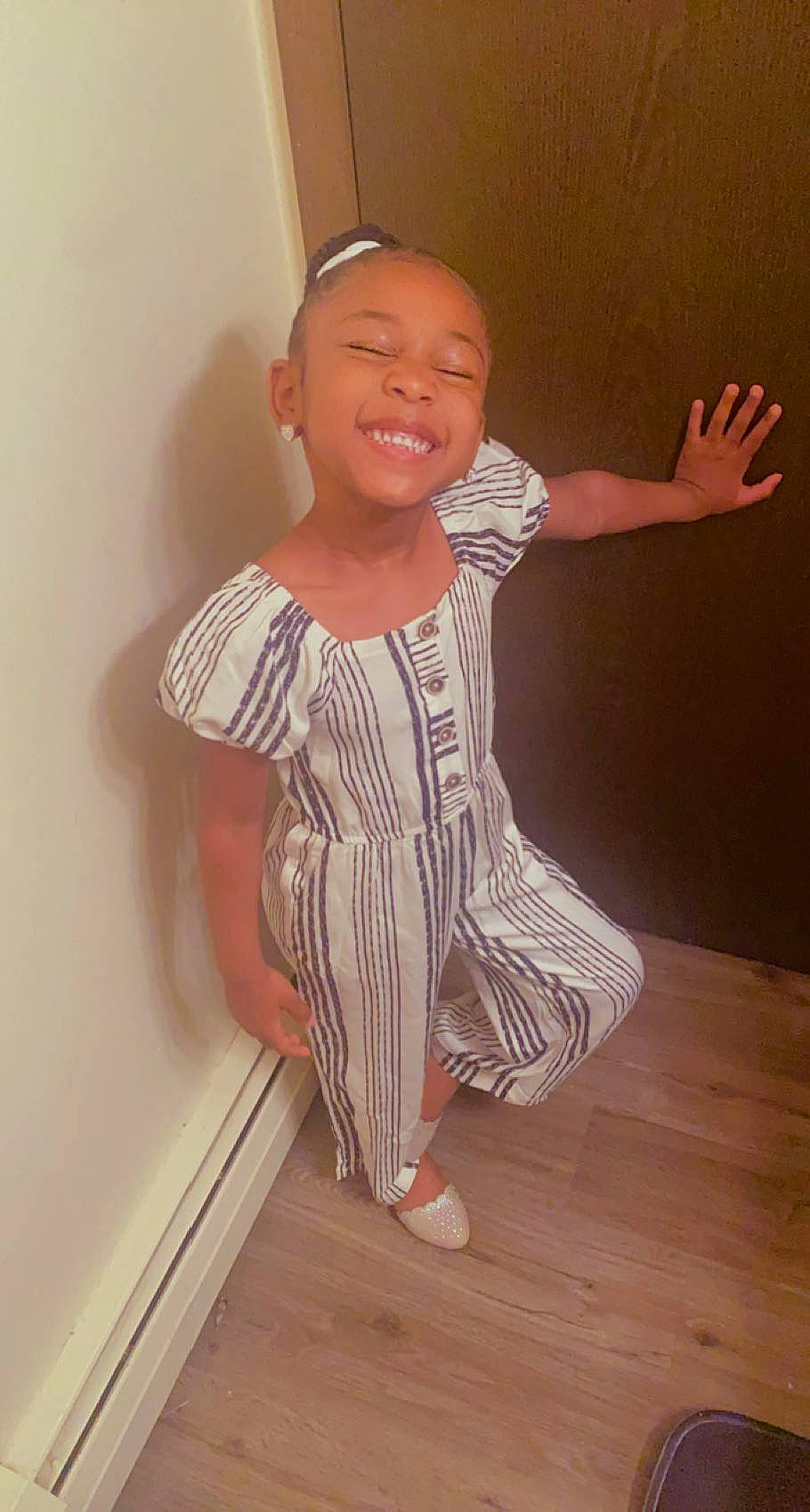 Loyalty Moss is registered to the contest to win money with this photo: arm, baby_toddler_clothing, chin, dress, eye, face, gesture, hair, hand, happy, human_body, joint, joy, leg, neck, person, shoulder, skin, sleeve, smile