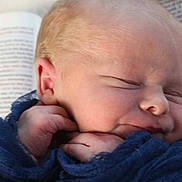 Nathan joined the competition — help win amazing prizes! newborn, baby, sleeping, blue_fabric, close_up, face, hands, resting, book, text, soft_light, infant, peaceful, skin, portrait, cute, young_child, indoors, human, tender