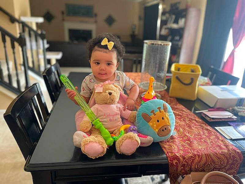 Aalayah is registered to the contest to win money with this photo: baby, baby_products, baby_toddler_clothing, baby_toys, chair, child, curtain, flag, fun, person, plate, play, room, sitting, smile, stuffed_toy, table, tableware, teddy_bear, toddler