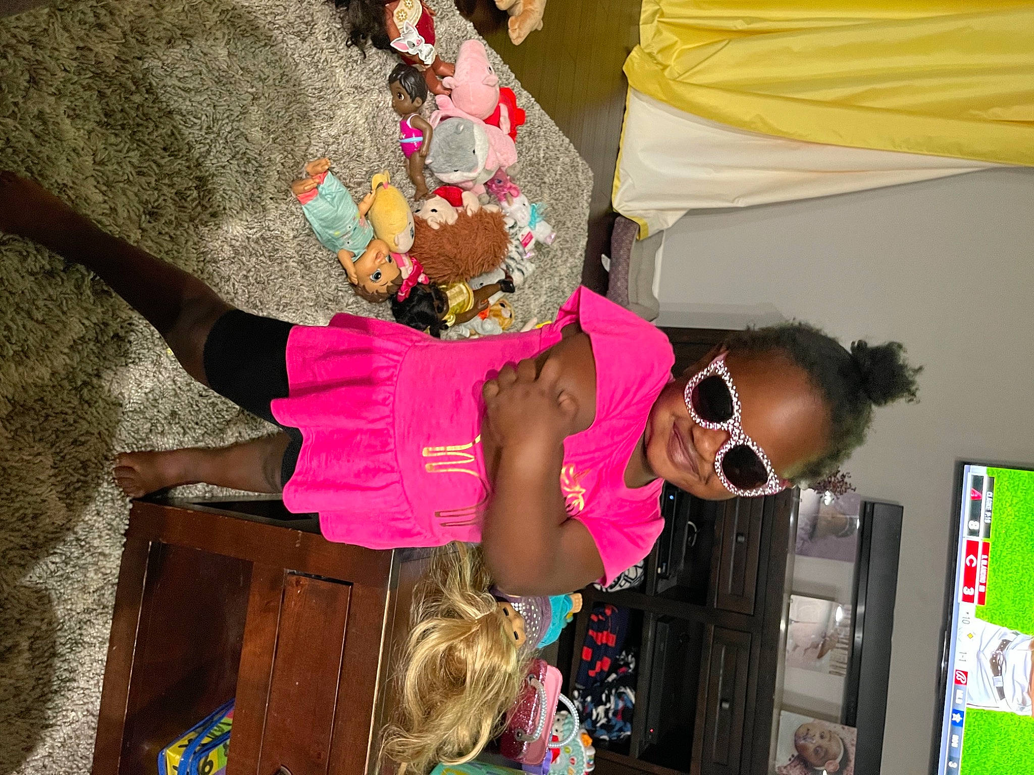 Loralei is registered to the contest to win money with this photo: child, costume, event, eyewear, fashion, fashion_accessory, fashion_design, fun, goggles, green, joy, leisure, magenta, pattern, people, person, pink, room, sunglasses, t_shirt