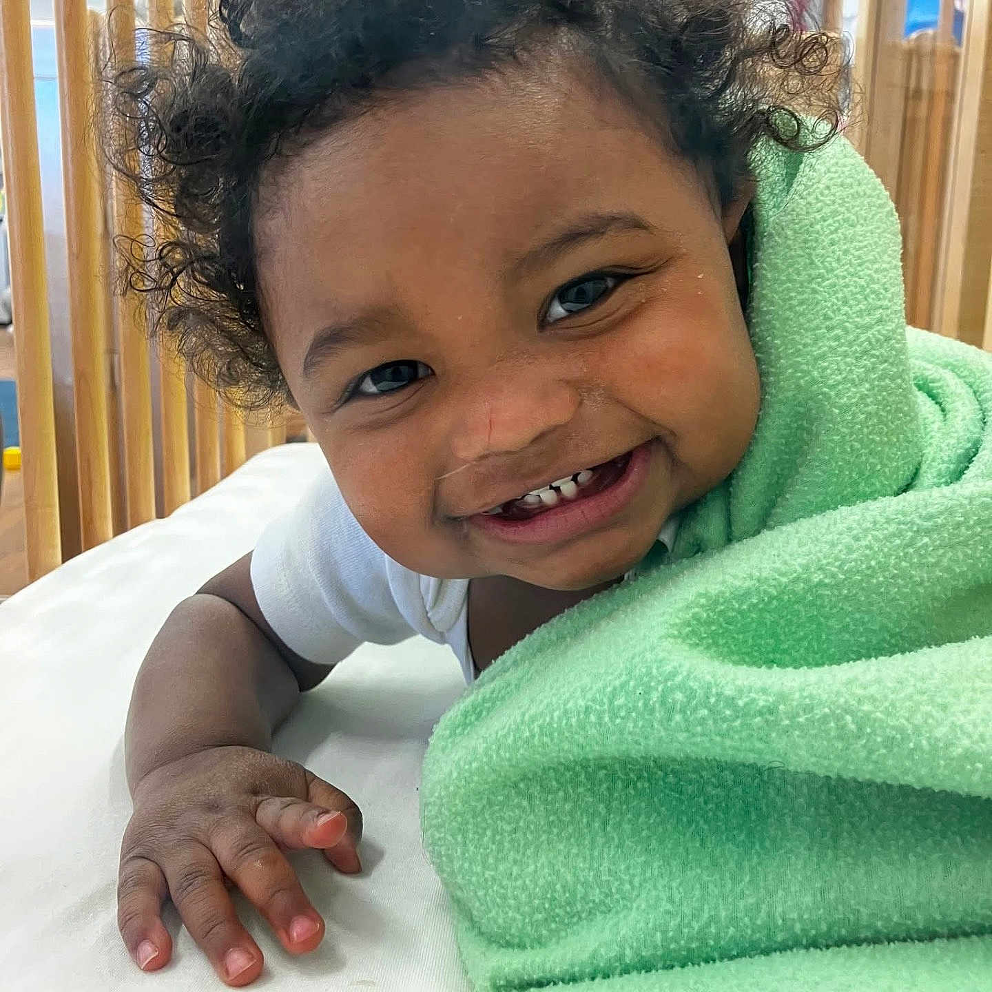 Prince joined the competition — help win amazing prizes! baby, blanket, child, close_up, crib, curly_hair, cute, face, green_blanket, hand, happy, indoors, person, portrait, skin, smile, teeth, toddler, white_clothing, wooden_crib