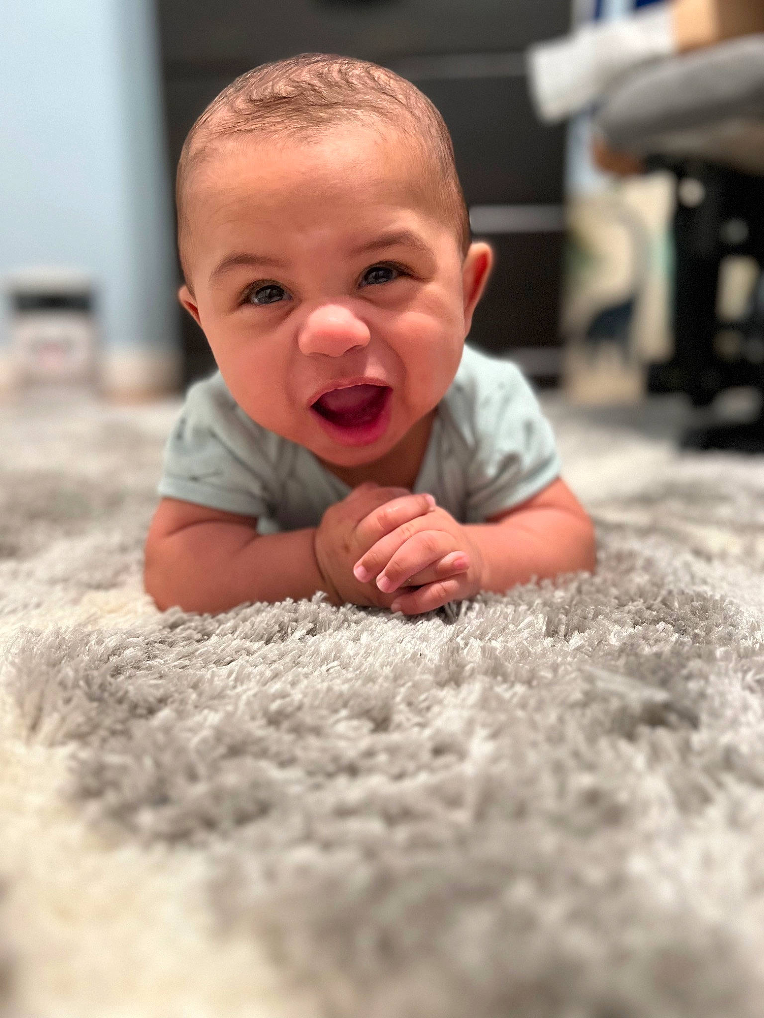 Jayceon is registered to the contest to win money with this photo: baby, baby_toddler_clothing, cheek, child, chin, comfort, crawling, floor, flooring, fun, grass, happy, head, nose, person, sitting, skin, smile, toddler, tummy_time