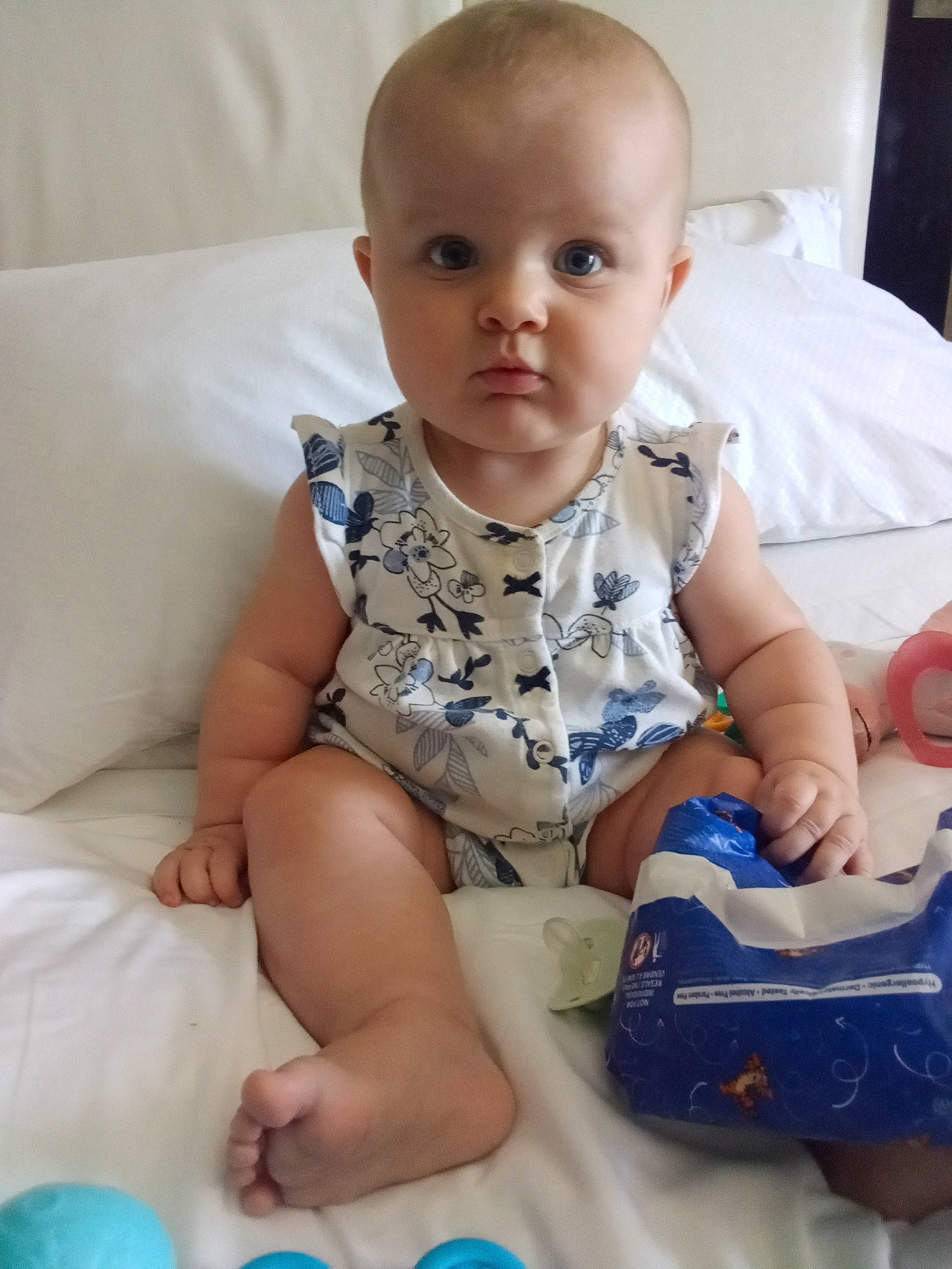 Scarlette is registered to the contest to win money with this photo: baby, baby_toddler_clothing, blue, cheek, child, comfort, finger, foot, fun, happy, human_body, iris, mouth, person, room, sitting, skin, sleeve, sock, toddler