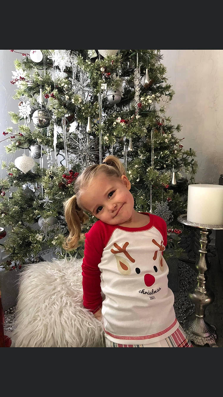 Addilyn is registered to the contest to win money with this photo: christmas, christmas_decoration, christmas_ornament, christmas_tree, event, evergreen, face, happy, holiday, holiday_ornament, human_body, joy, lamp, ornament, person, plant, sleeve, smile, toddler, tree
