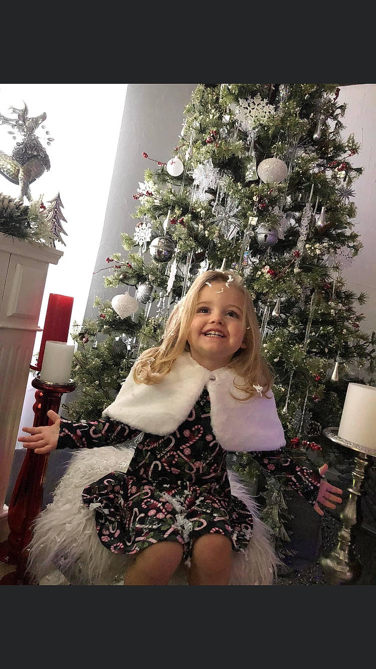 Addilyn is registered to the contest to win money with this photo: christmas, christmas_decoration, christmas_eve, christmas_ornament, christmas_tree, conifer, dress, event, evergreen, eye, happy, holiday, holiday_ornament, human_body, joy, ornament, pattern, person, plant, smile