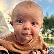 Lia joined the competition — help win amazing prizes! baby, infant, face, blue_eyes, drool, blanket, outdoor, sky, sunset, trees, closeup, portrait, clothing, sleeves, hand, curious, head, expression, young_child, nature