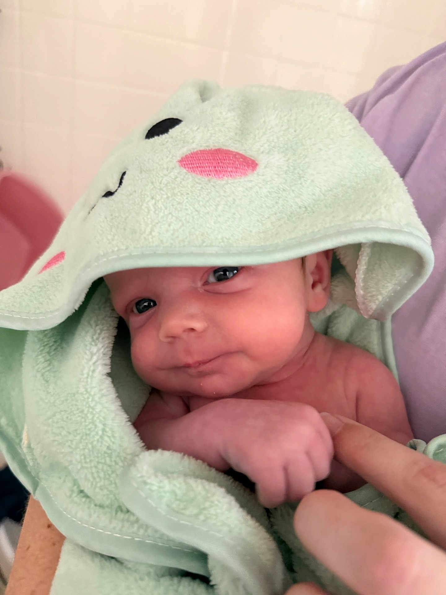 Liam joined the competition — help win amazing prizes! baby, infant, towel, hood, cute, soft, skin, hand, finger, person, child, newborn, indoors, closeup, expression, face, gaze, comfort, care, blanket