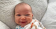 Jaylen joined the competition — help win amazing prizes! baby, smiling, infant, onesie, animal_print, cushion, cozy, happy, face, child, cute, soft_texture, indoors, portrait, young_child, comfort, relaxing, sleepwear, person, closeup