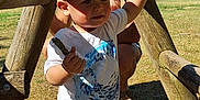 Angel participe au concours pour gagner de l'argent avec cette photo : toddler, child, cap, tshirt, shorts, stick, wooden_structure, playground, adult, sunglasses, grass, outdoor, sunlight, shadow, summer, nature, person, exploration, fun, daytime