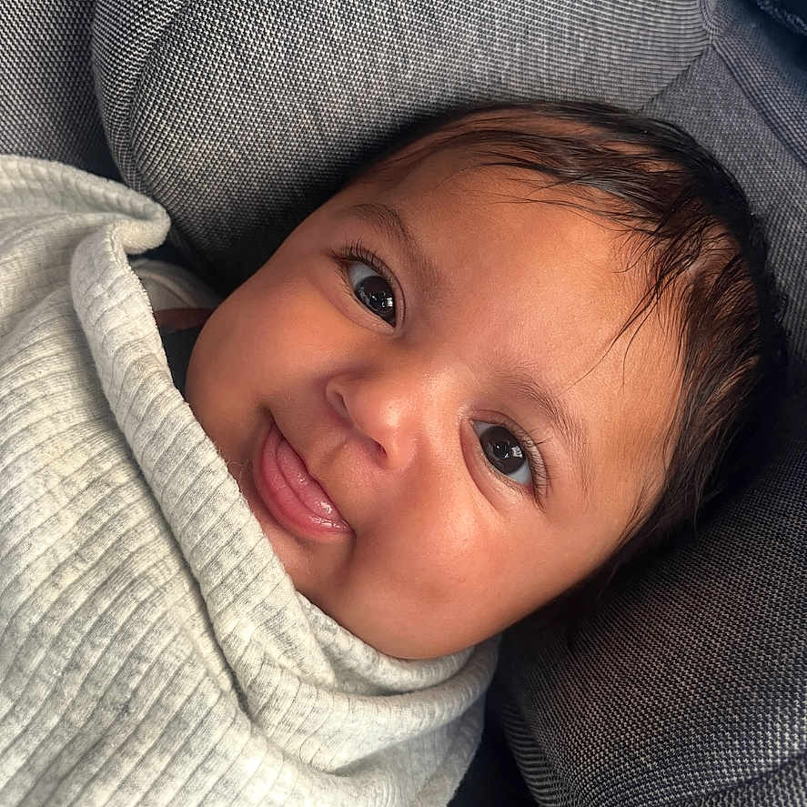 Logan David is registered to the contest to win money with this photo: baby, bodypart, cap, clothing, face, finger, hand, happy, hat, head, hood, hoodie, knitwear, newborn, person, photography, portrait, smile, sweater, sweatshirt