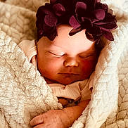 Maliyah is registered to the contest to win money with this photo: baby, sleeping, blanket, headband, flower, purple, infant, cozy, soft, cute, wrapped, peaceful, child, newborn, hand, skin, face, rest, comfort, portrait