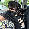 animal, bag, black_cat, bow, car_interior, casual, cat, closeup, feline, greenery, indoor, leopard_print, parking_lot, person, pet, pirate_theme, seatbelt, shoulder, torn_shirt, window