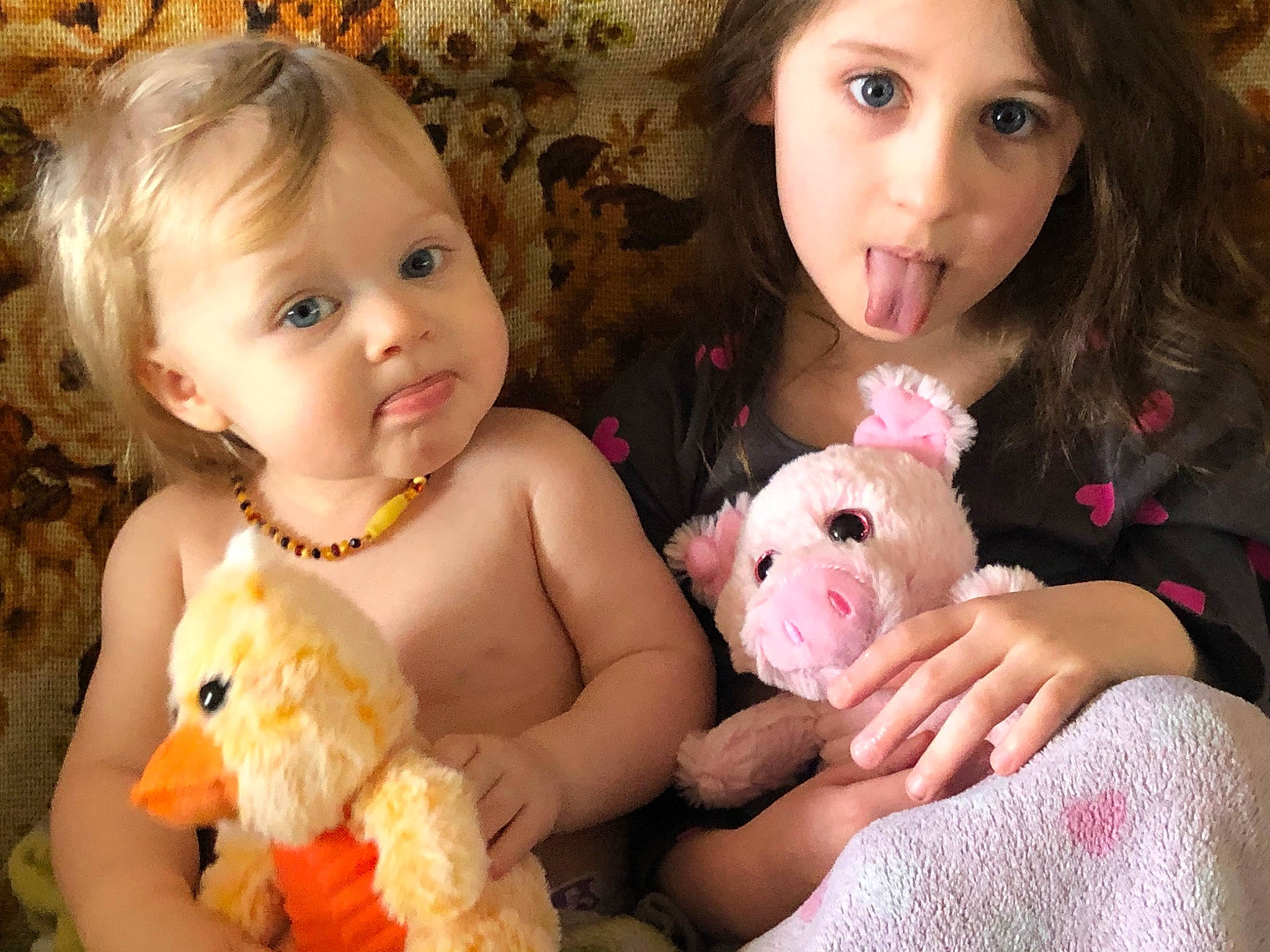 Marceline is registered to the contest to win money with this photo: baby, cheek, child, eye, face, family, fur, iris, nose, person, pink, sibling, skin, smile, stuffed_toy, teddy_bear, toddler, toy