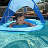 Michael joined the competition — help win amazing prizes! baby, blue, canopy, child, curious, daylight, face, fence, furniture, inflatable_float, outdoor, pensive, pool, relaxing, safety, summer, sunny, swimming_pool, water, water_droplets