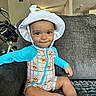 Enzo joined the competition — help win amazing prizes! toddler, child, hat, onesie, winnie_the_pooh, couch, gray_couch, smile, indoor, living_room, furniture, foot, barefoot, person, baby, chandelier, bicycle, curious, cute, playful