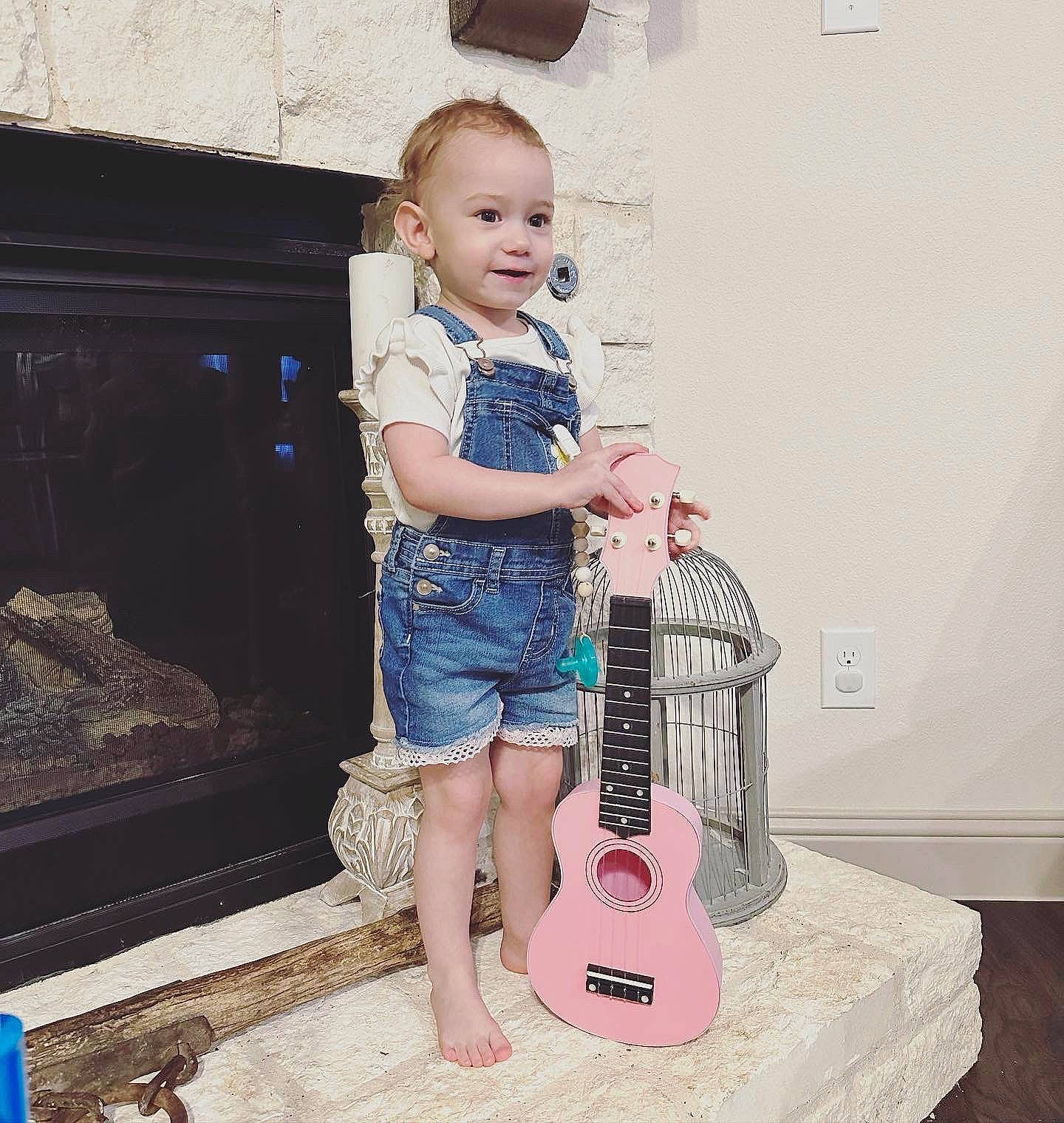 Kayleigh is registered to the contest to win money with this photo: baby_toddler_clothing, beauty, floor, flooring, folk_instrument, guitar, guitar_accessory, happy, musical_instrument, musical_instrument_accessory, musician, person, photograph, plucked_string_instruments, product, smile, standing, string_instrument, string_instrument_accessory, t_shirt