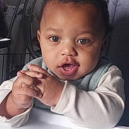 Kaden joined the competition — help win amazing prizes! baby, child, high_chair, hands, curious, indoor, face, person, clothing, window, blinds, furniture, expression, young, skin, hair, mouth, eyes, table, light