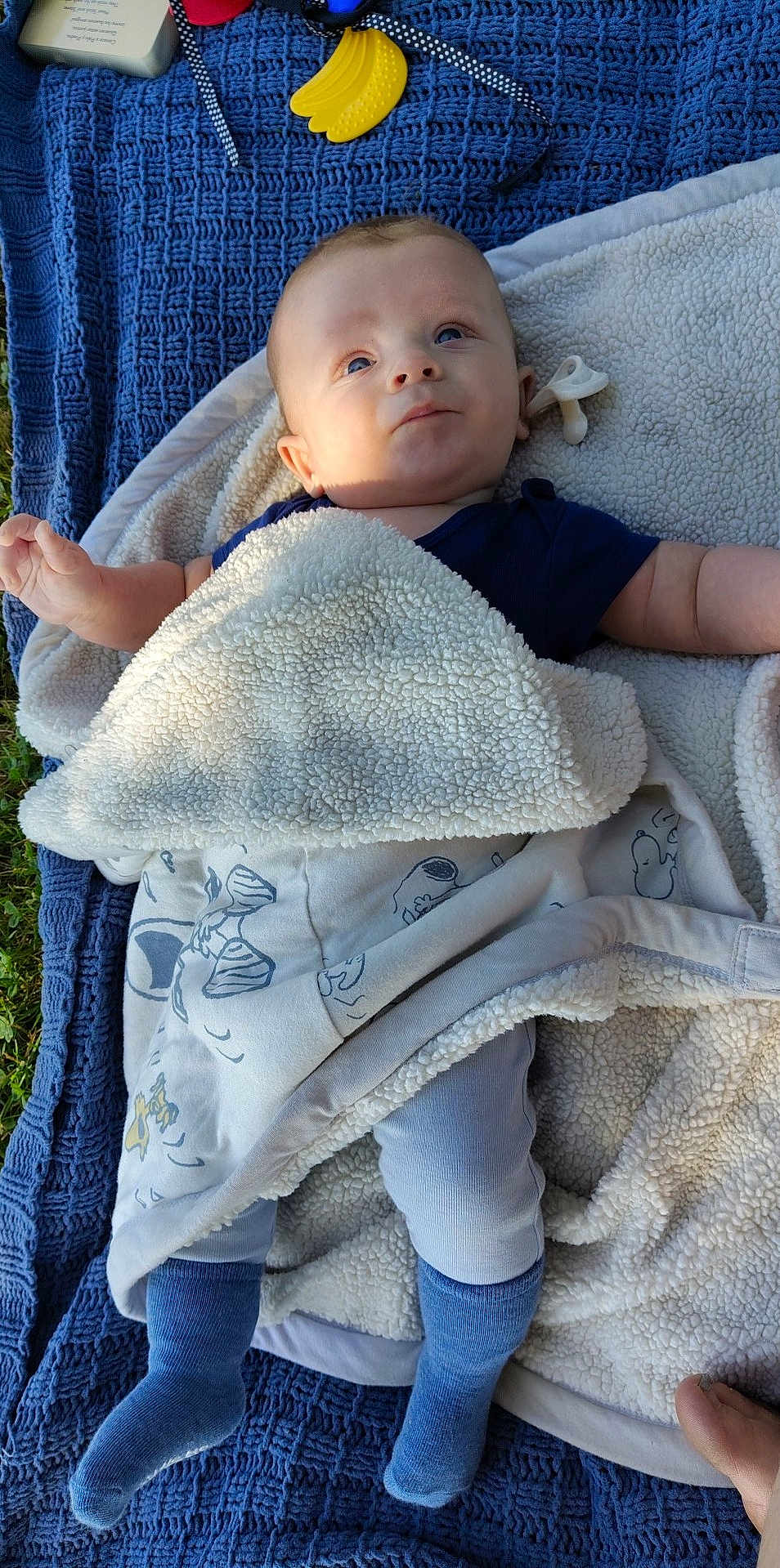 Hudson joined the competition — help win amazing prizes! baby, blanket, blue_socks, child, cozy, curious_expression, cute, fabric, face, grass, infant, lying_down, outdoor, pacifier, peaceful, small_hands, soft_texture, toy, warm_clothing, wrapped
