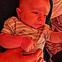 Hudson is registered to the contest to win money with this photo: baby, infant, striped_clothing, hand, person, close_up, skin, cute, newborn, holding, indoor, soft_lighting, child, human, portrait, baby_clothes, gentle, expression, warm_colors, resting