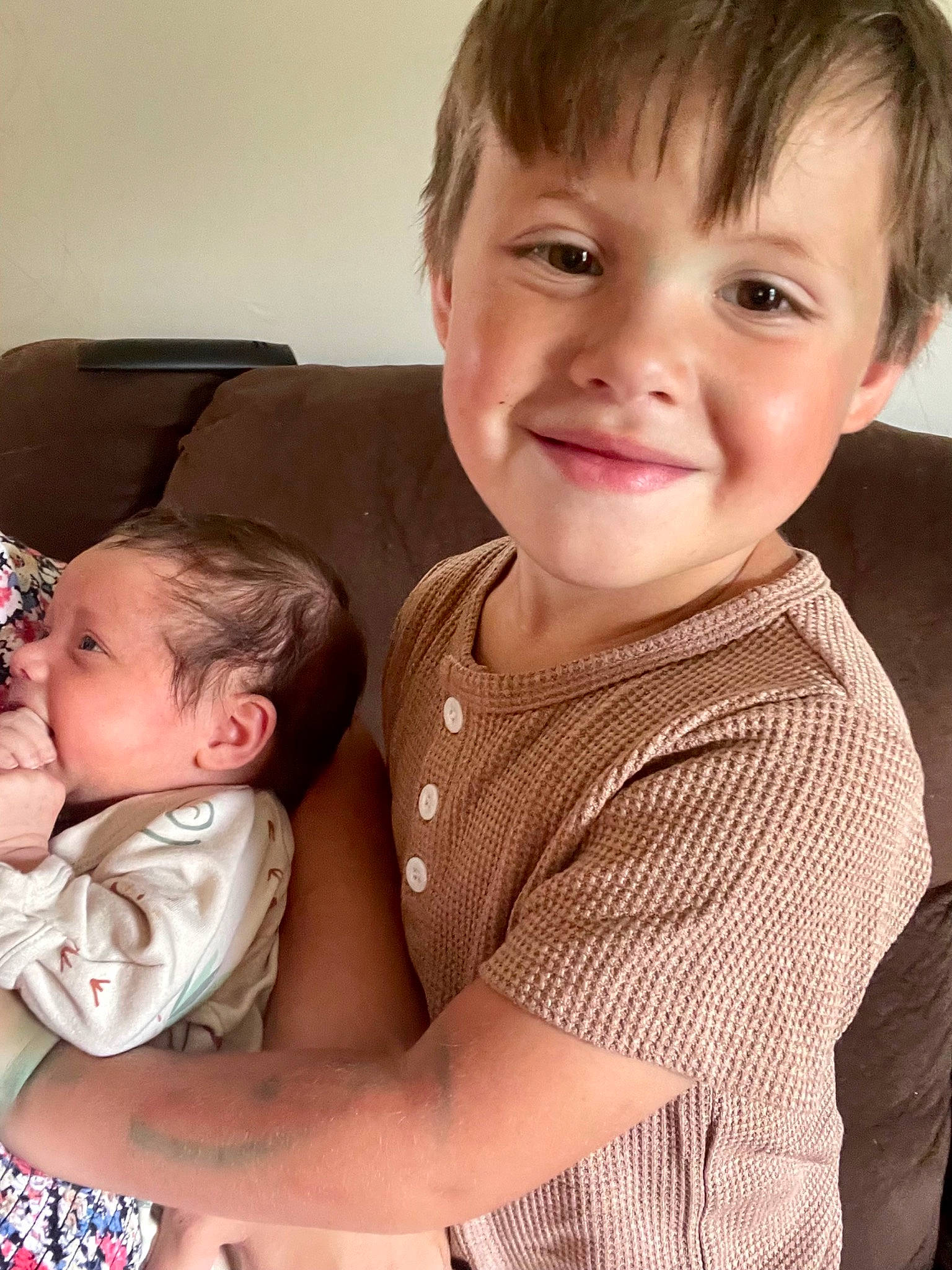 August is registered to the contest to win money with this photo: baby, baby_toddler_clothing, bangs, cheek, child, collar, comfort, couch, fun, happy, iris, joy, lap, nose, pattern, person, sitting, skin, sleeve, smile