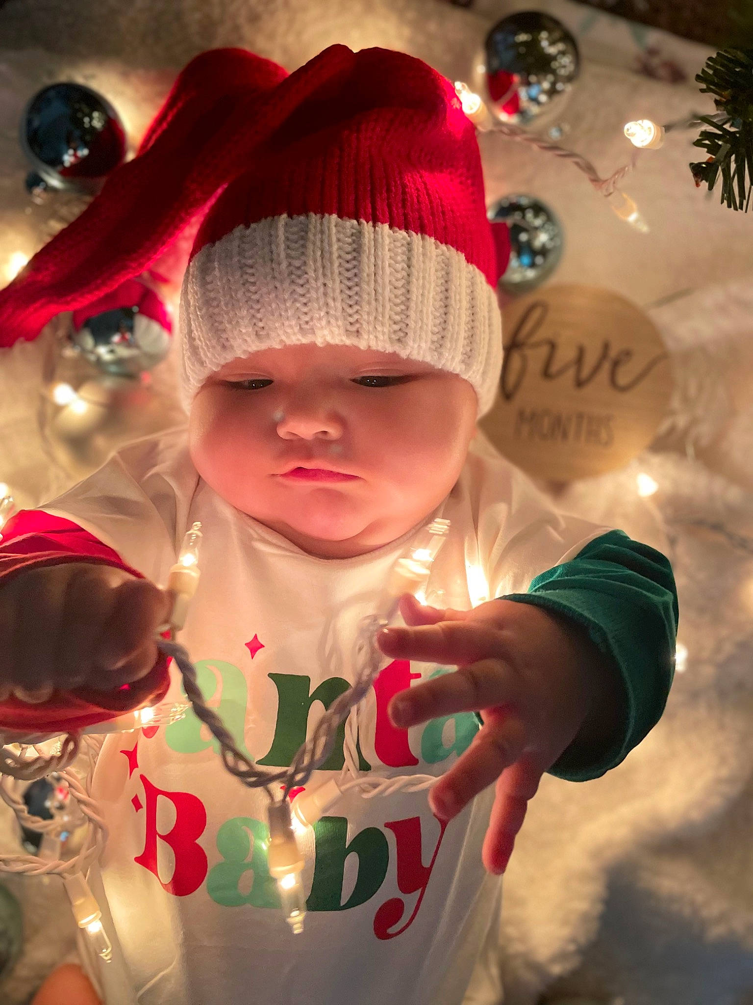 Ariyah is registered to the contest to win money with this photo: cap, carmine, child, christmas, christmas_eve, event, fashion_accessory, fictional_character, flesh, fun, happy, headwear, holiday, knit_cap, ornament, pattern, person, sleeve, toddler, tradition