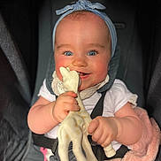 Alba participe au concours pour gagner de l'argent avec cette photo : baby, child, blue_eyes, headband, giraffe_toy, car_seat, smiling, happy, rosy_cheeks, infant, white_clothing, seatbelt, cute, hands, chewing, portrait, indoor, closeup, toy, baby_toy
