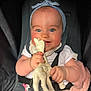 baby, child, blue_eyes, headband, giraffe_toy, car_seat, smiling, happy, rosy_cheeks, infant, white_clothing, seatbelt, cute, hands, chewing, portrait, indoor, closeup, toy, baby_toy