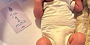 Liam a rejoint le concours — aidez-le/la à gagner de superbes lots ! baby, infant, pacifier, onesie, blanket, card, newborn, lying_down, soft_fabric, cute, small, child, skin, foot, hand, face, indoors, sleepwear, resting, one_month