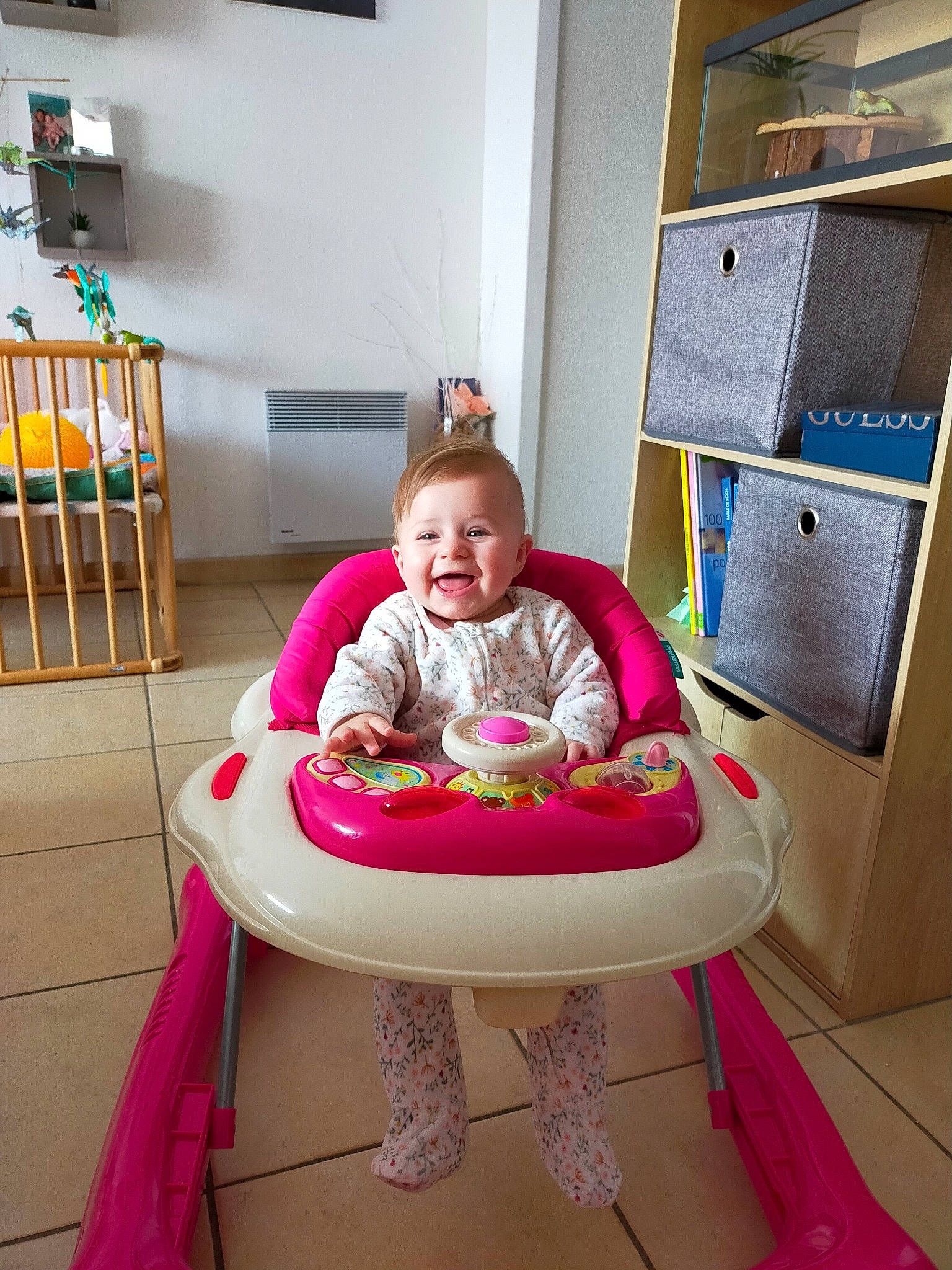 Elena a rejoint le concours — aidez-le/la à gagner de superbes lots ! baby, baby_products, baby_safety, baby_toddler_clothing, baby_toys, cabinetry, chair, child, comfort, flooring, furniture, leisure, magenta, person, pink, purple, shelf, sitting, smile, toddler