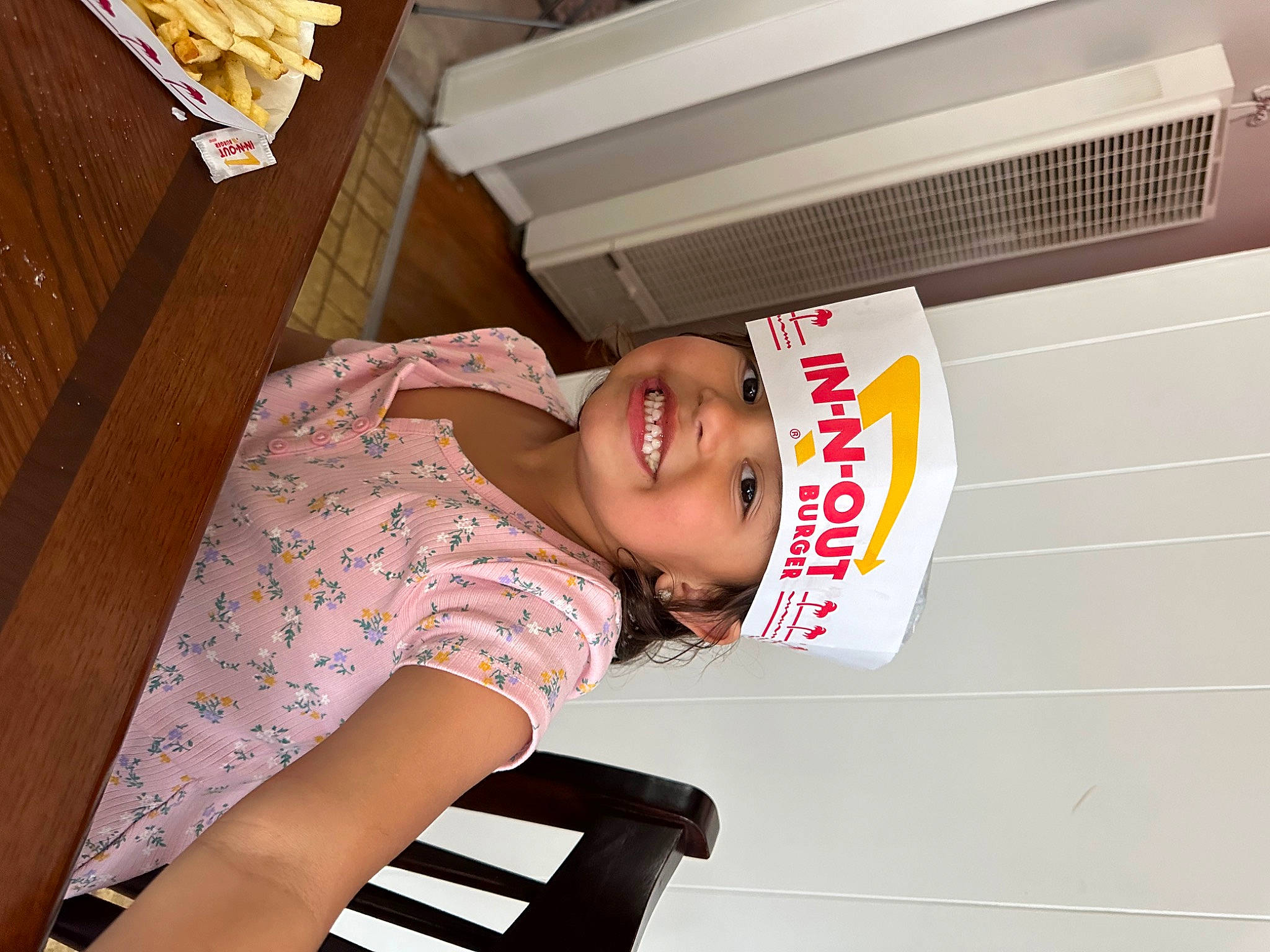 Mila is registered to the contest to win money with this photo: child, comfort, elbow, fashion_design, hardwood, headwear, human_leg, joy, musical_instrument, pattern, person, room, smile, t_shirt, thigh, wood